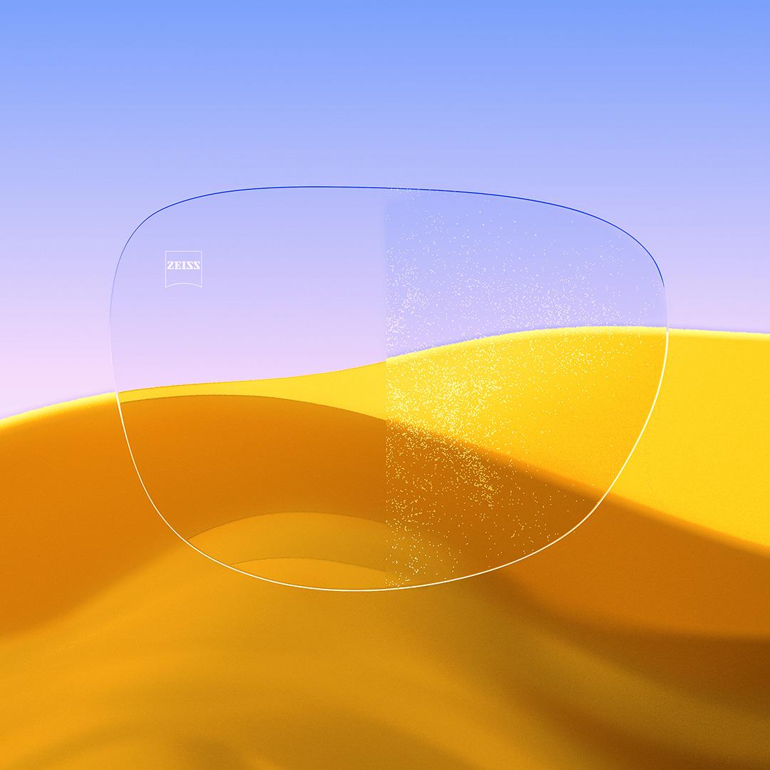 Lente con prescripción dividido: con un lado transparente y limpio con ZEISS DuraVision Gold UV y un lado con polvo que cubre el lente.