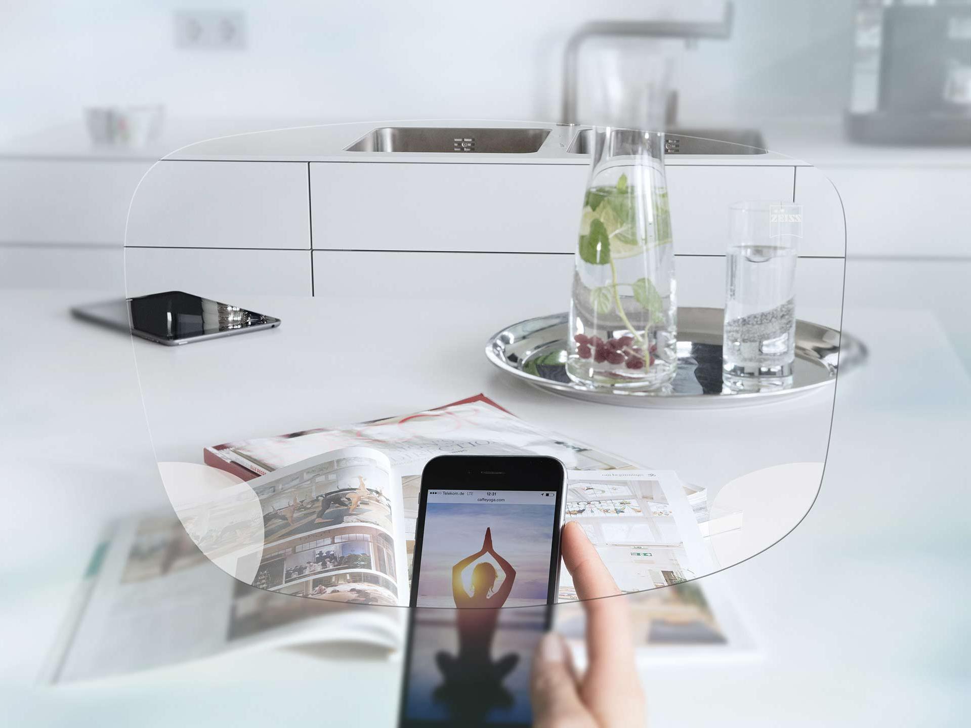 View through ZEISS EnergizeMe Single Vision Spectacle Lens at smartphone screen and organised kitchen table