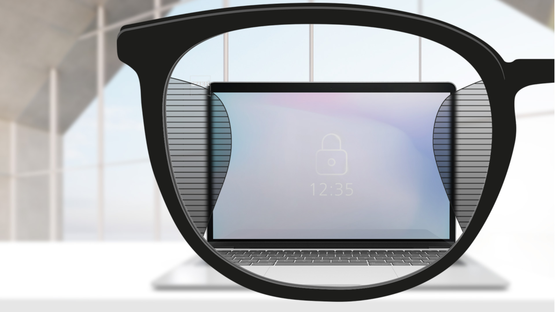 Imagen de un punto de vista con lentes de oficina ZEISS Office con una pantalla de computador en el centro del lente y zonas borrosas a izquierda y derecha.