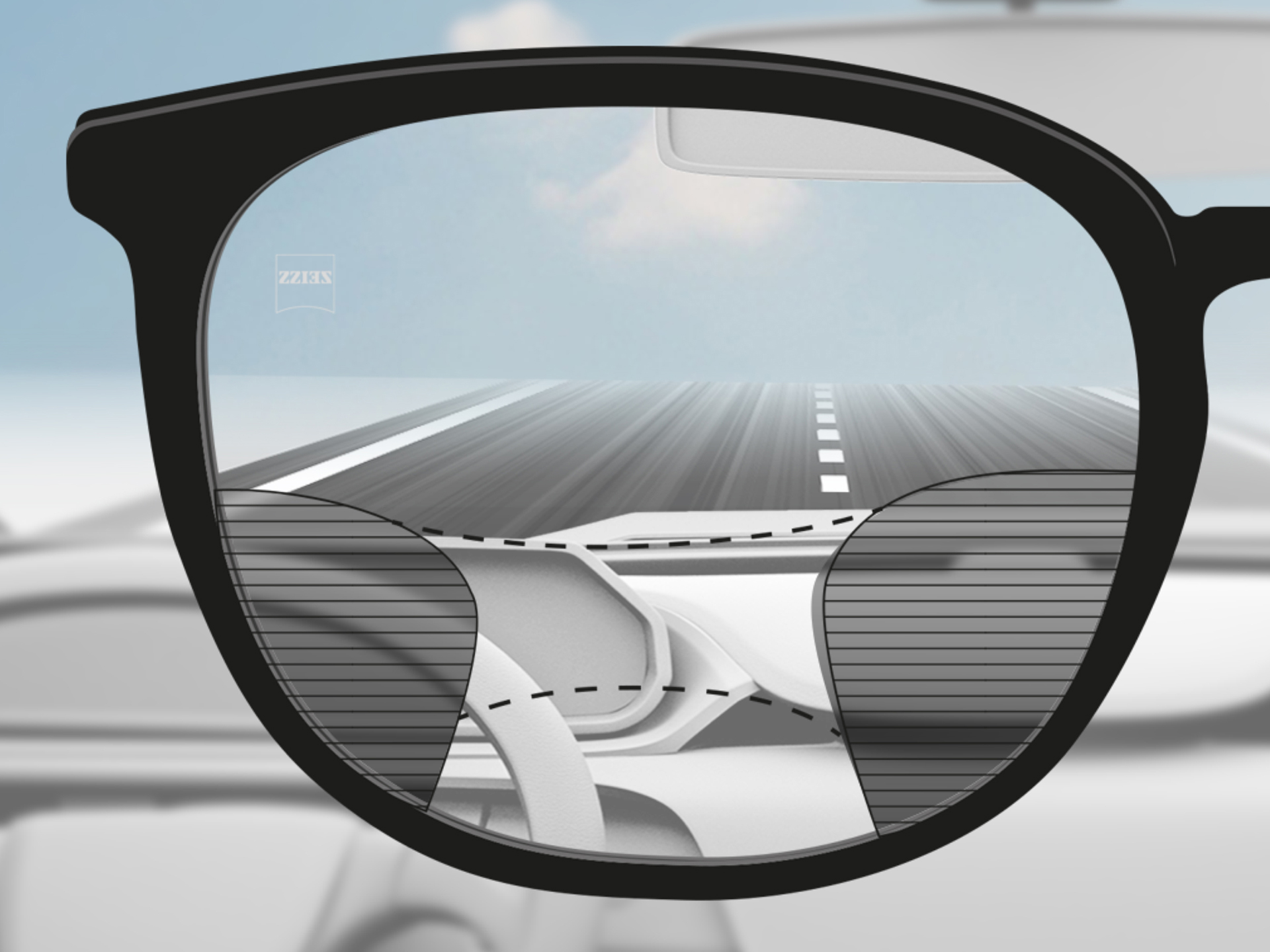 Imagen de un punto de vista a través de un lente progresivo ZEISS DriveSafe: las zonas de visión se han adaptado para que el conductor tenga zonas de visión nítida sobre la carretera y el tablero.