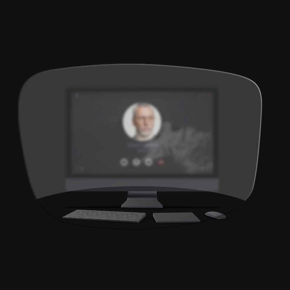 La vista de un computador de mesa, un teclado, un ratón y un libro a través de una ilustración esquemática de unos lentes para leer muestra que solo los objetos cercanos son nítidamente visibles. La pantalla del computador está borrosa.